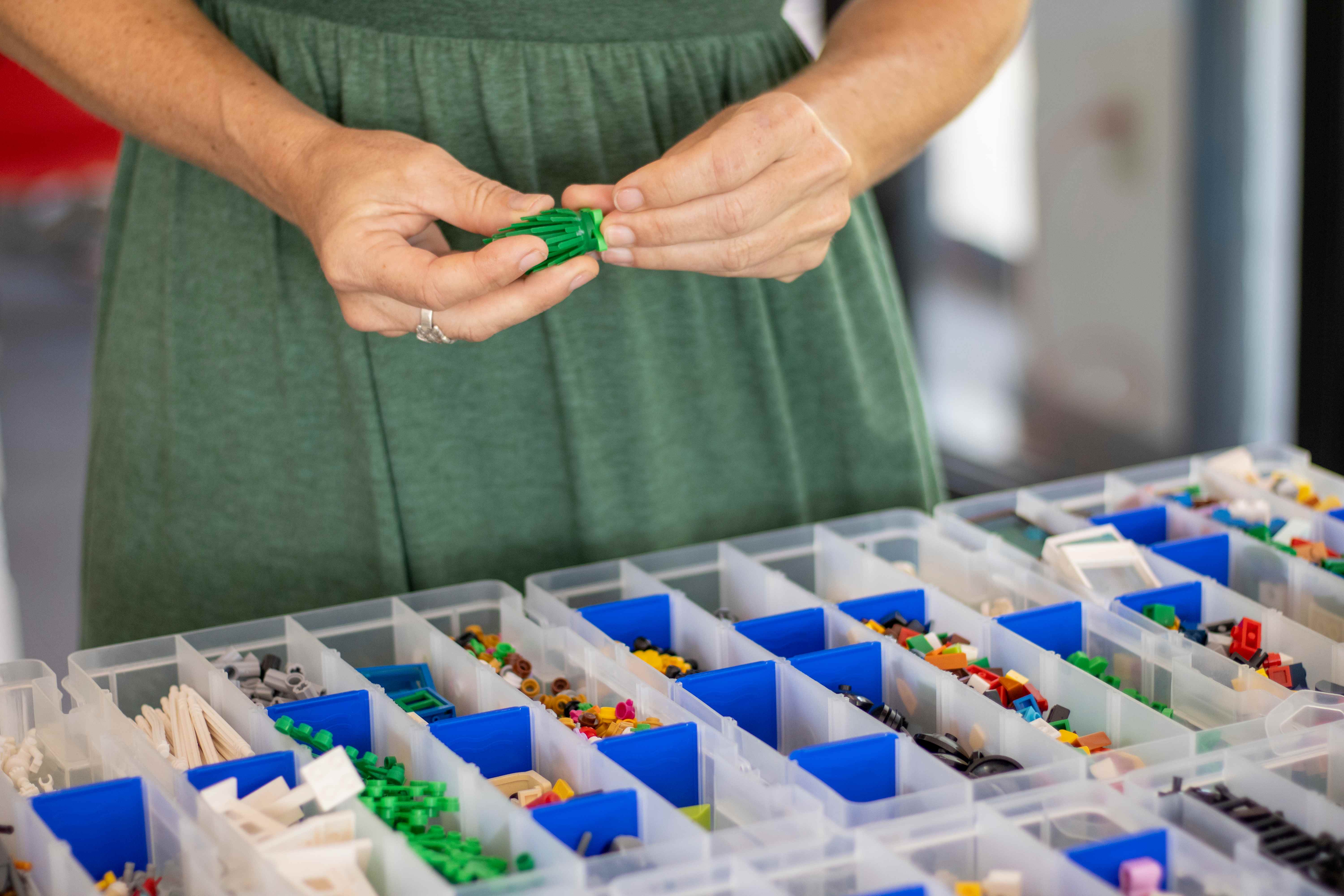 Hands building with LEGO